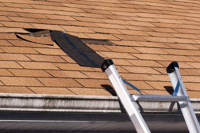 Damaged roof with shingles missing